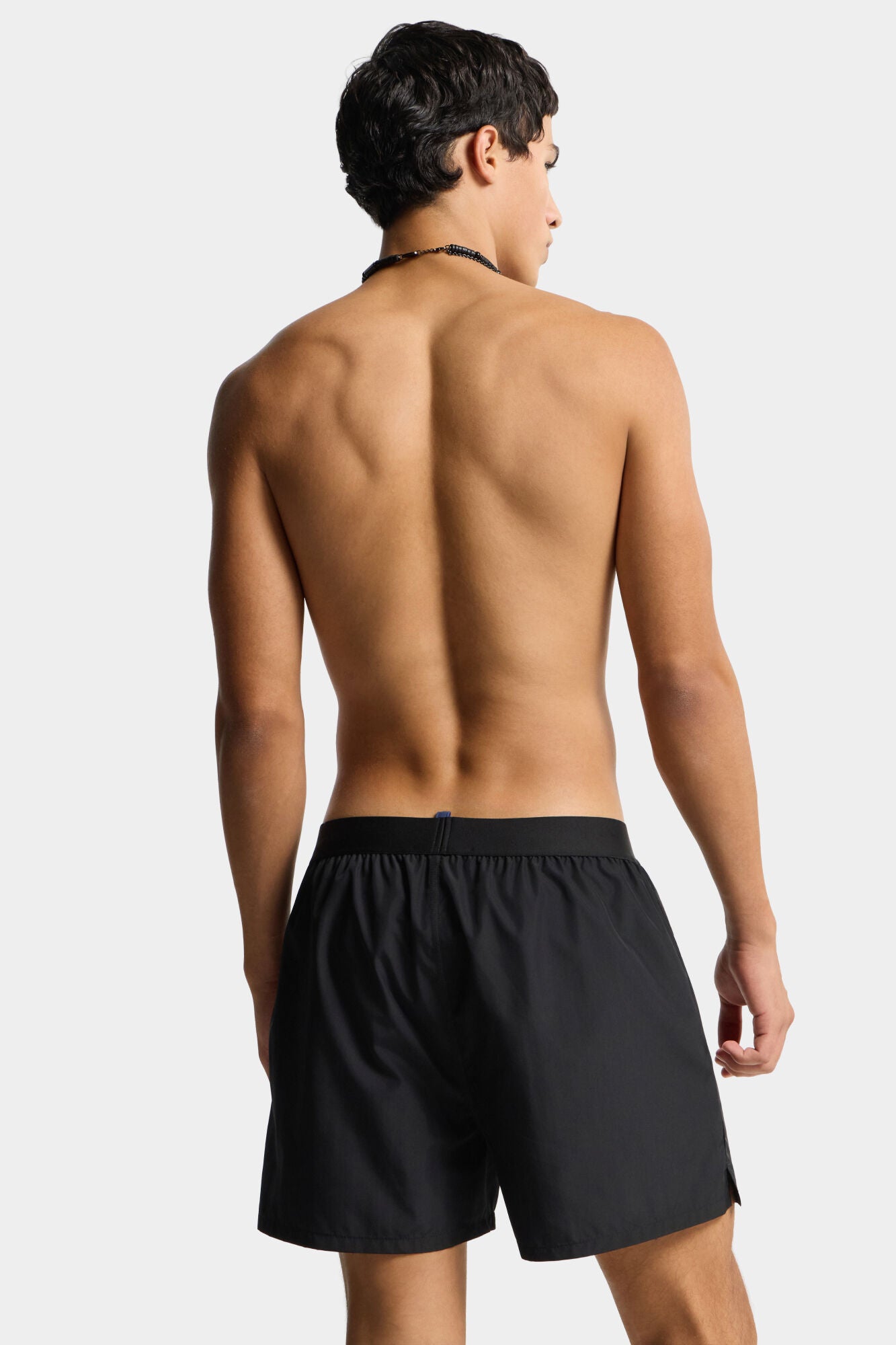 Black shorts with Dsquared2 logo on a light gray background