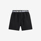 Black shorts with Dsquared2 logo on a light gray background