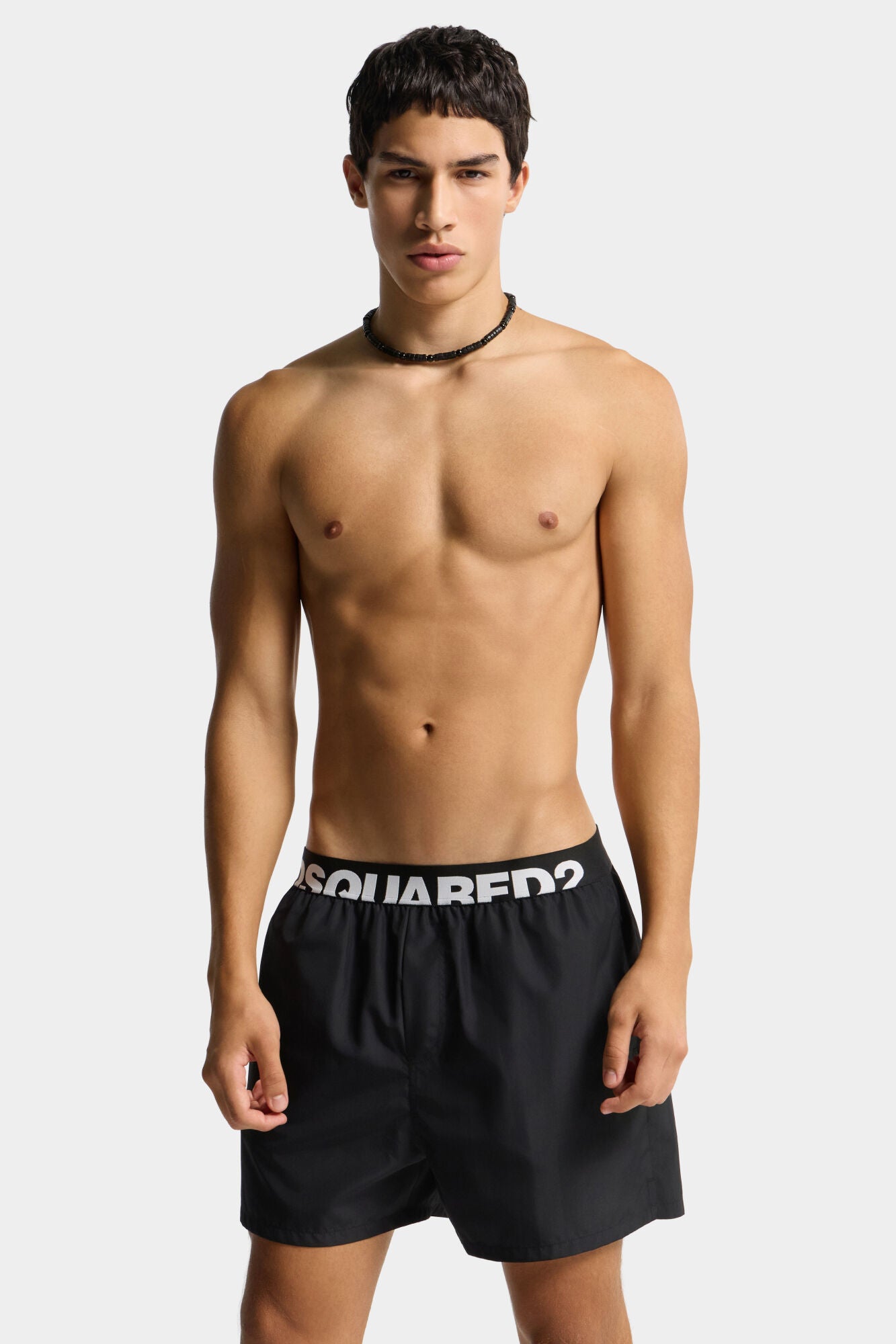 Black shorts with Dsquared2 logo on a light gray background
