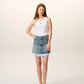 White tank top with a small black design on a beige background