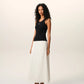 Black tank top with a small white logo on a beige background