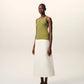 Green tank top with a small black logo on a beige background
