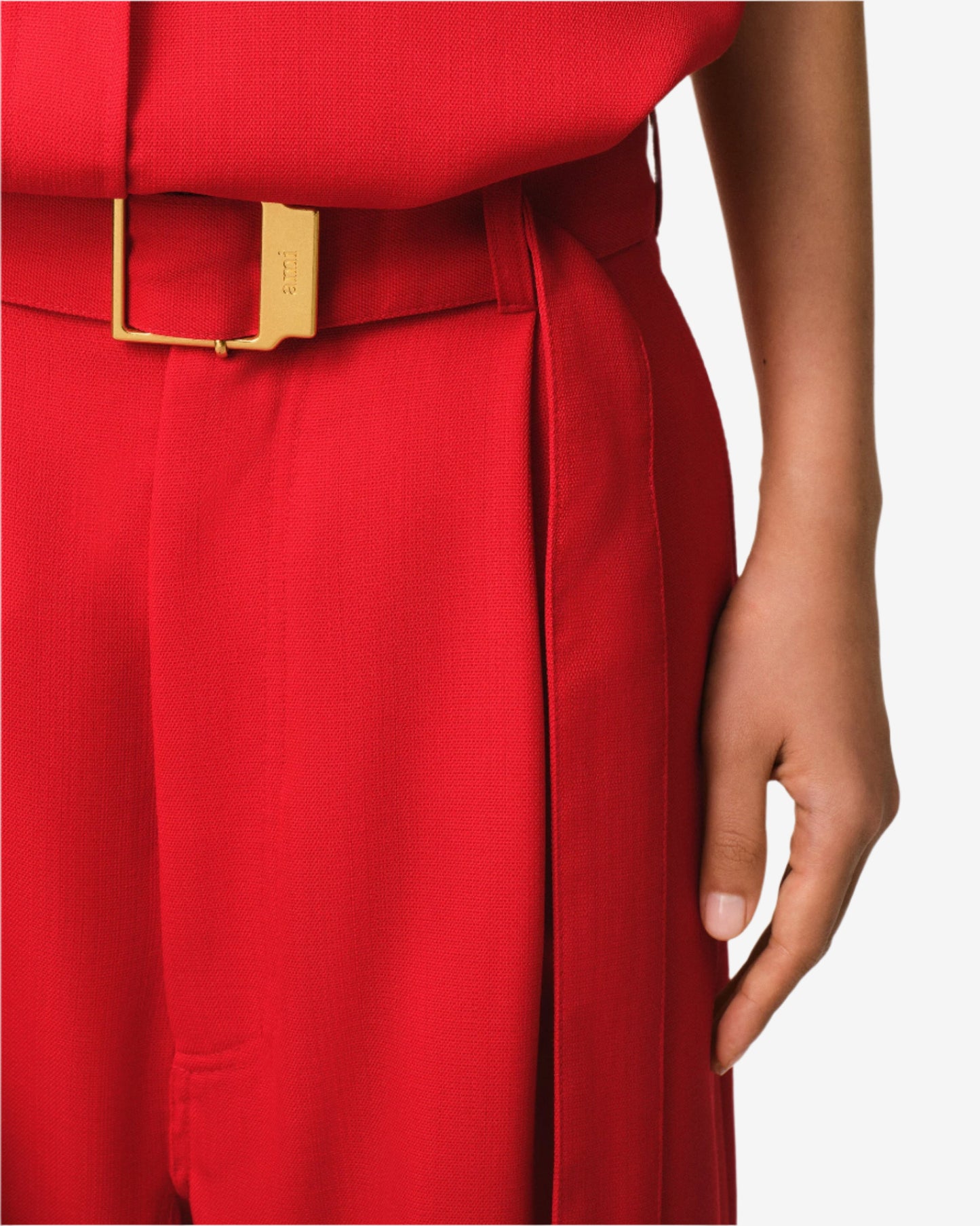Red outfit with a gold belt on a neutral background