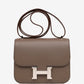 Brown handbag with a silver clasp on a white background hermes