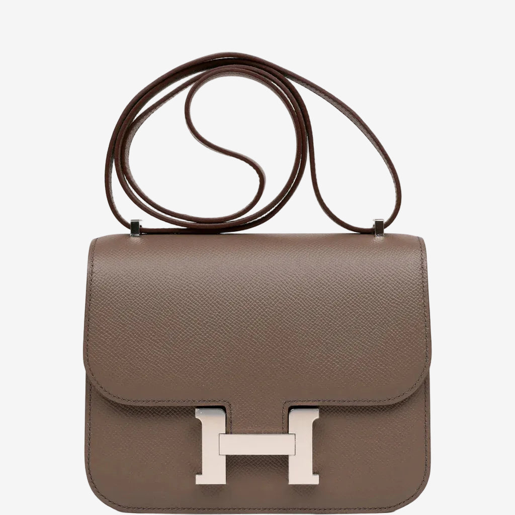 Brown handbag with a silver clasp on a white background hermes