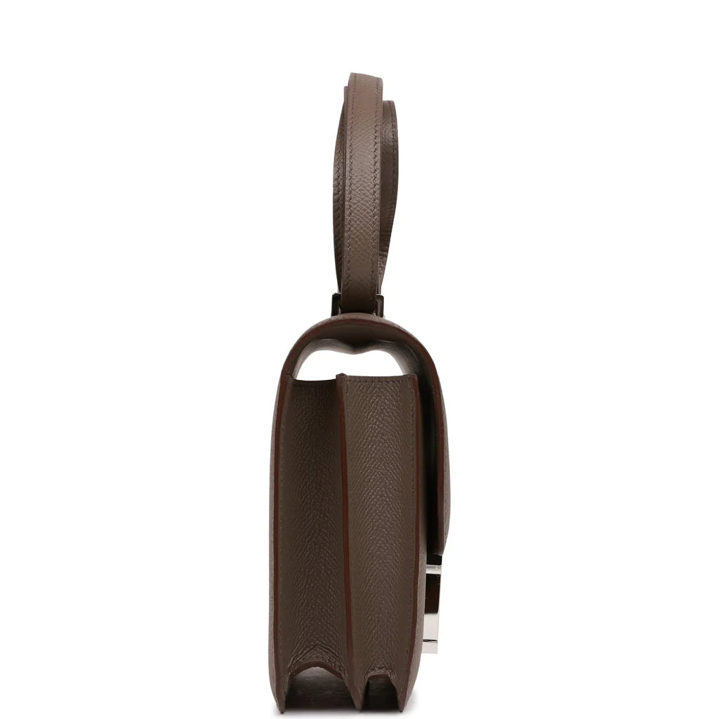 Brown handbag with a silver clasp on a white background hermes