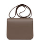 Brown handbag with a silver clasp on a white background hermes