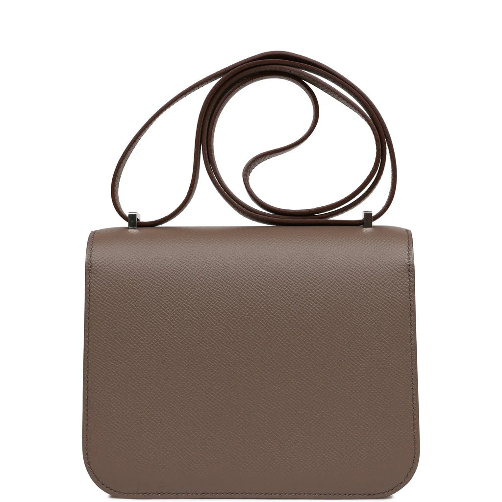 Brown handbag with a silver clasp on a white background hermes