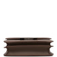 Brown handbag with a silver clasp on a white background hermes