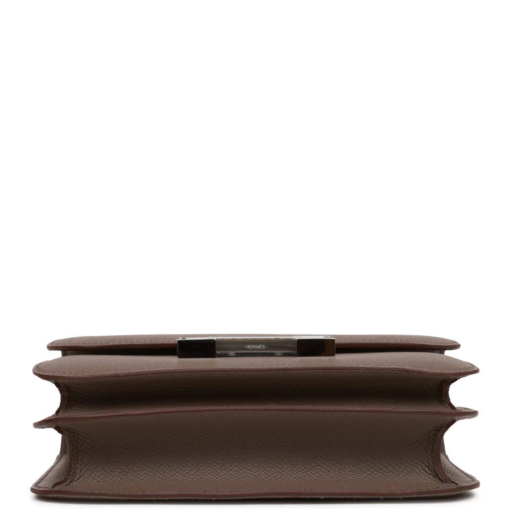 Brown handbag with a silver clasp on a white background hermes