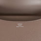 Brown handbag with a silver clasp on a white background hermes