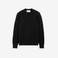 Black sweater on a beige background