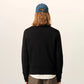 Black sweater on a beige background