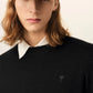 Black sweater on a beige background