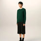 Green sweater on a beige background