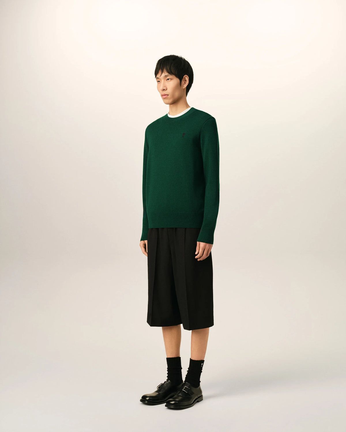 Green sweater on a beige background