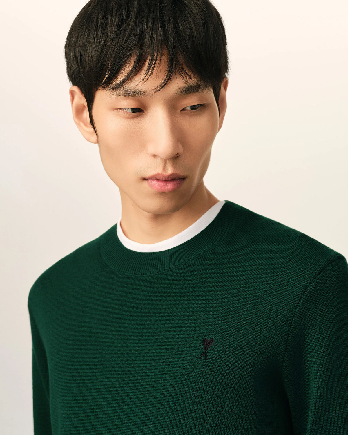 Green sweater on a beige background