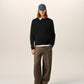 Black sweater on a beige background