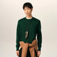 Green sweater on a beige background