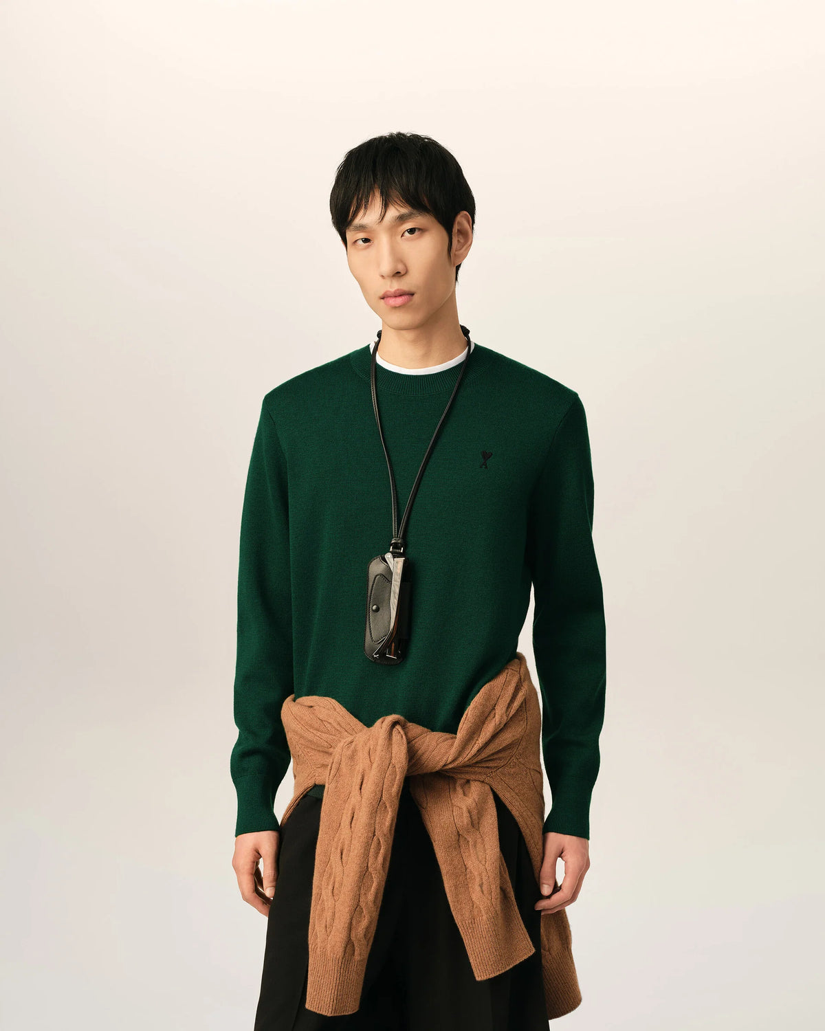 Green sweater on a beige background