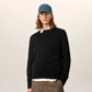 Black sweater on a beige background