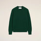 Green sweater on a beige background