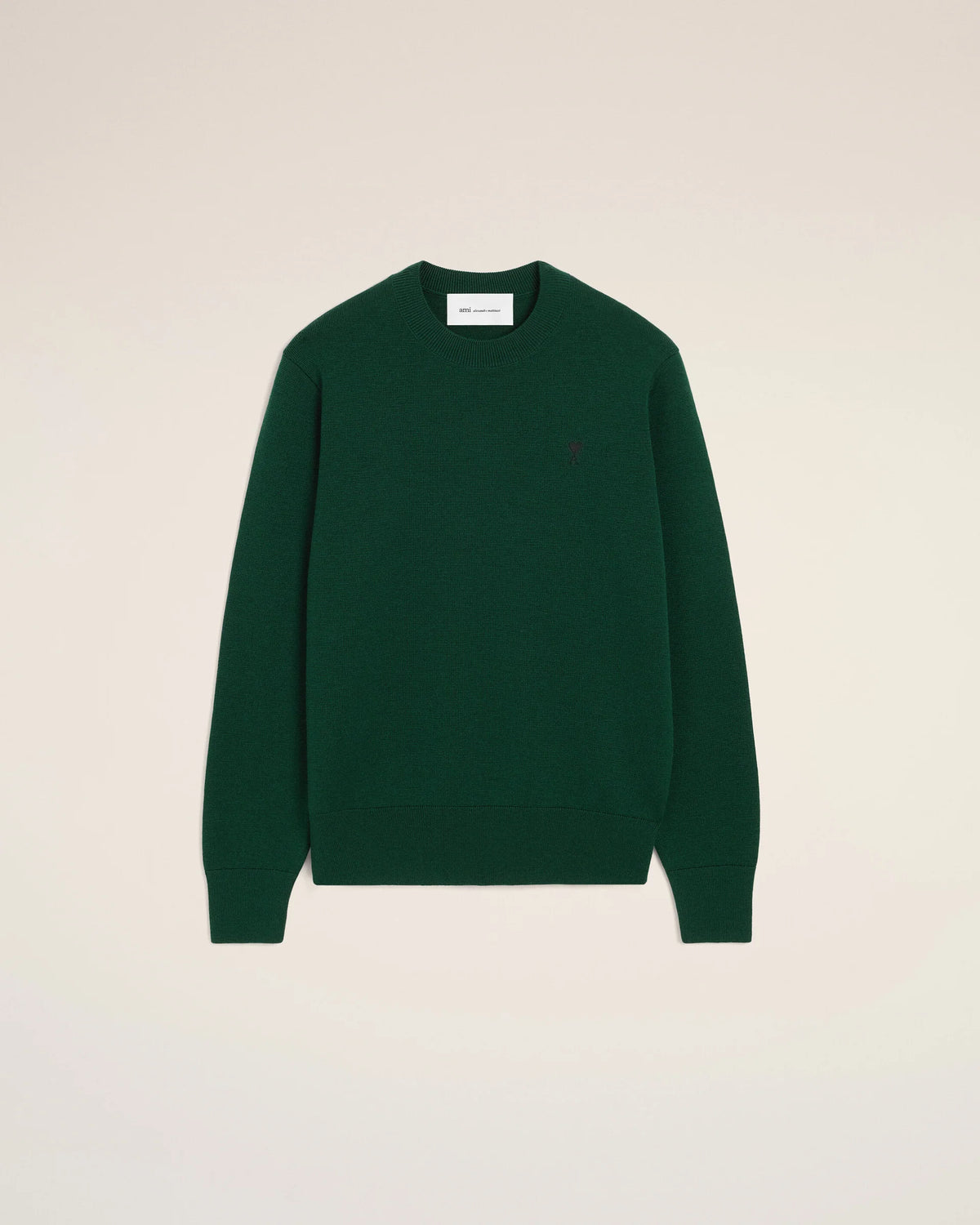 Green sweater on a beige background