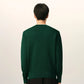 Green sweater on a beige background