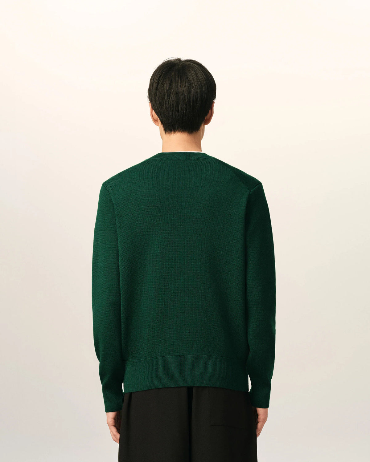 Green sweater on a beige background