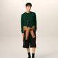 Green sweater on a beige background