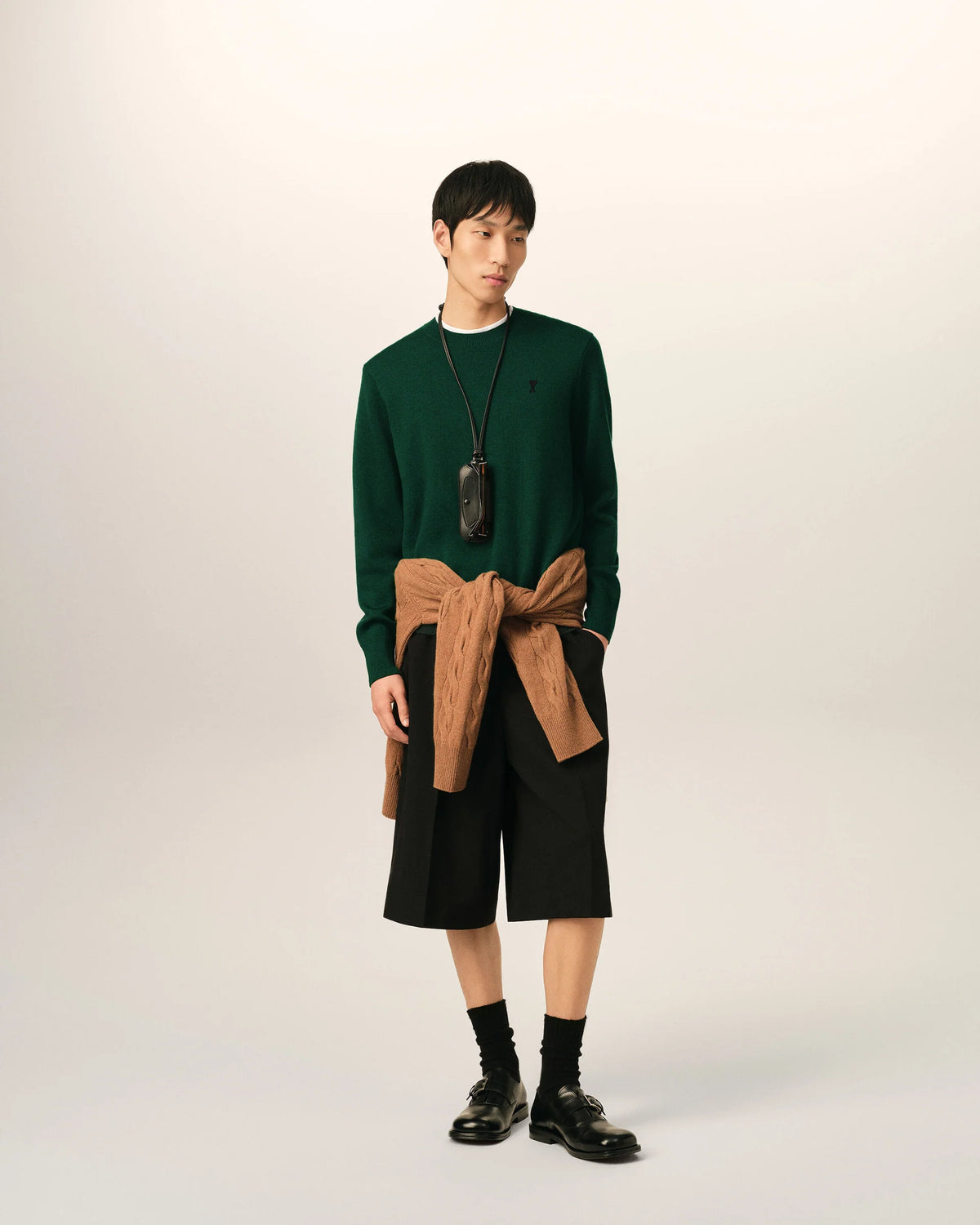 Green sweater on a beige background