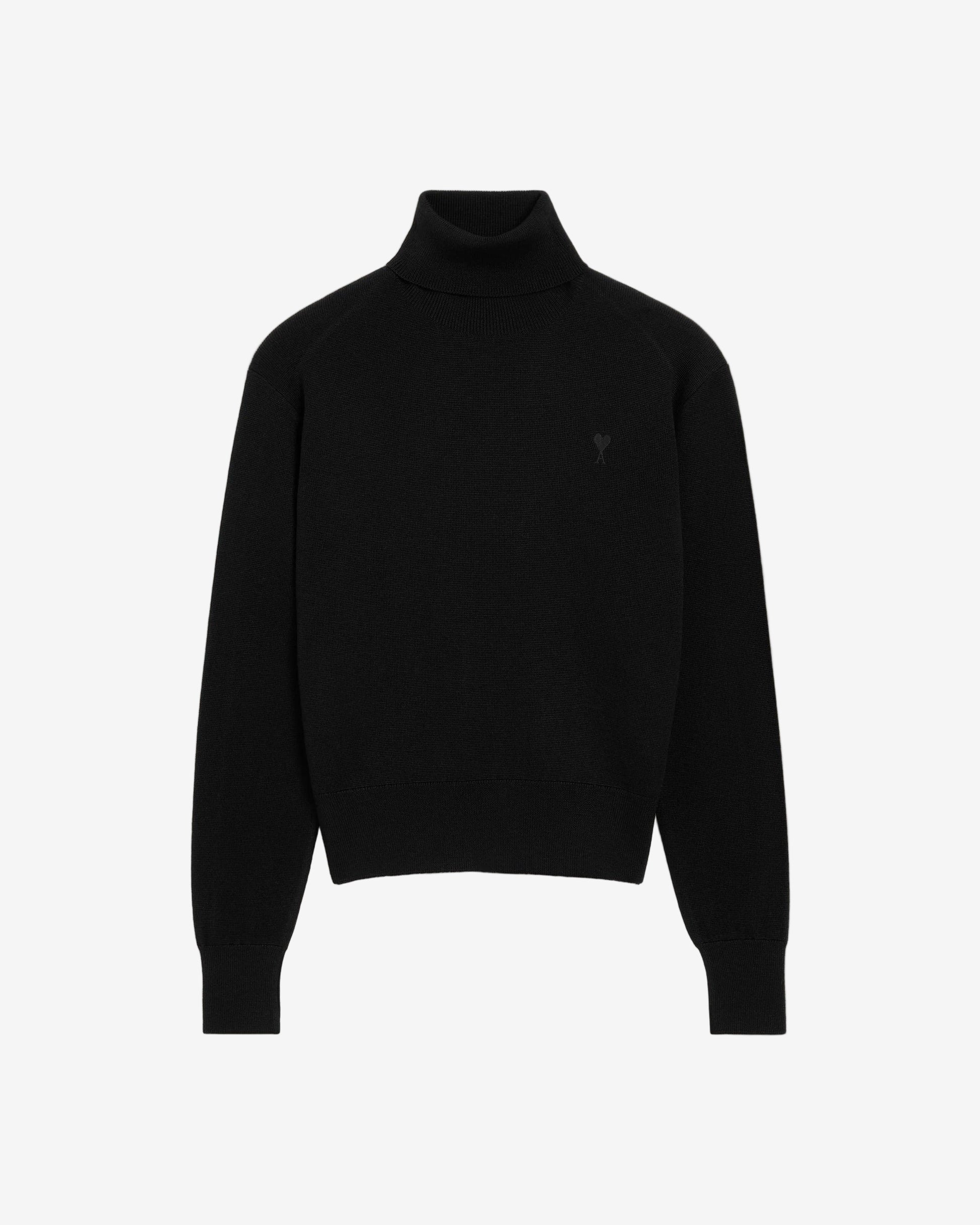 Black turtleneck sweater on a beige background