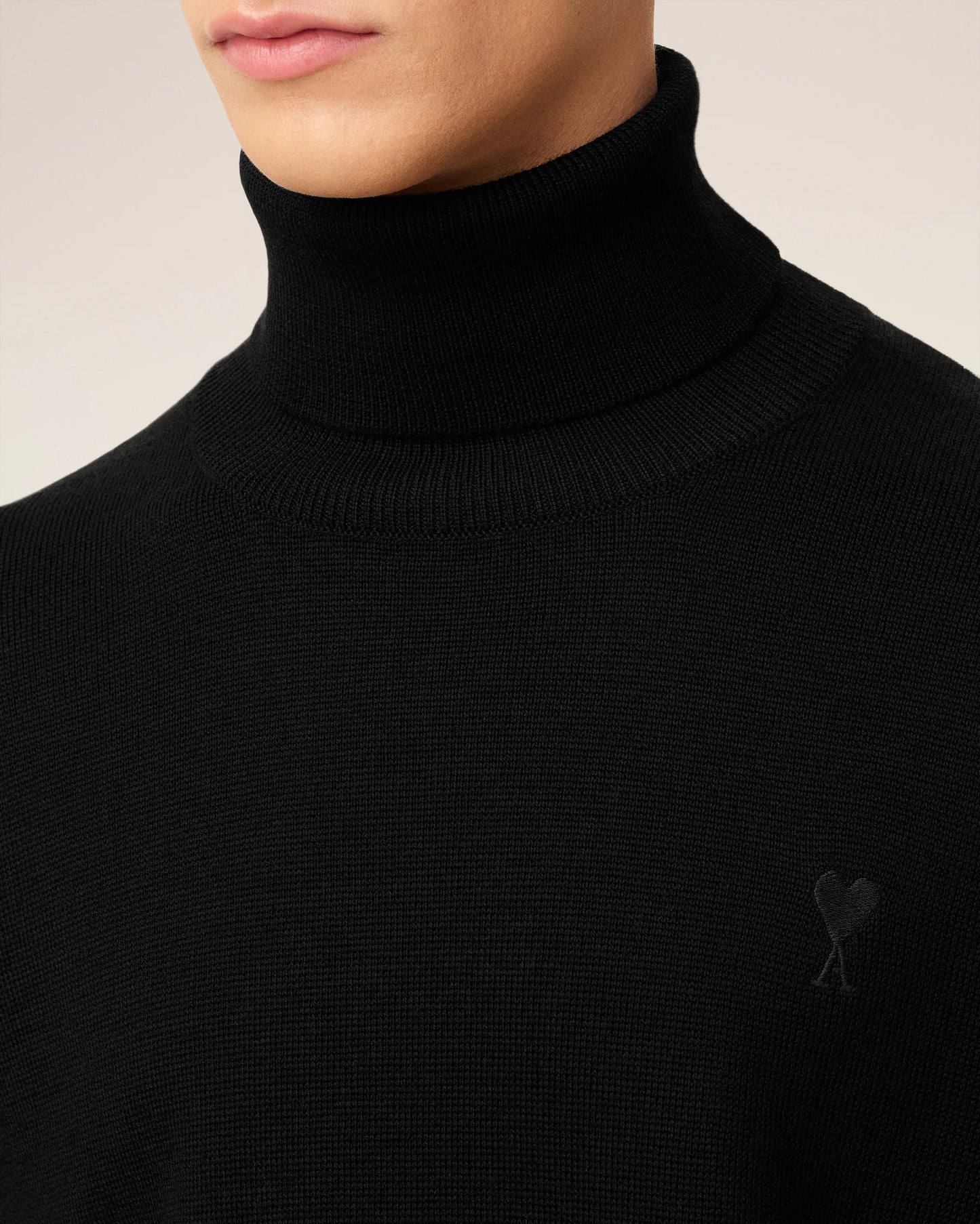 Black turtleneck sweater on a beige background