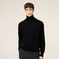 Black turtleneck sweater on a beige background