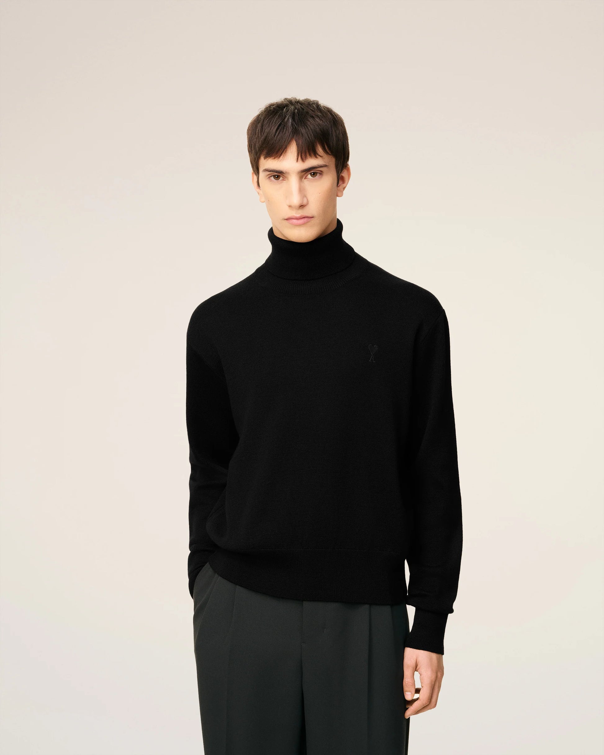 Black turtleneck sweater on a beige background