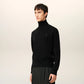 Black turtleneck sweater on a beige background