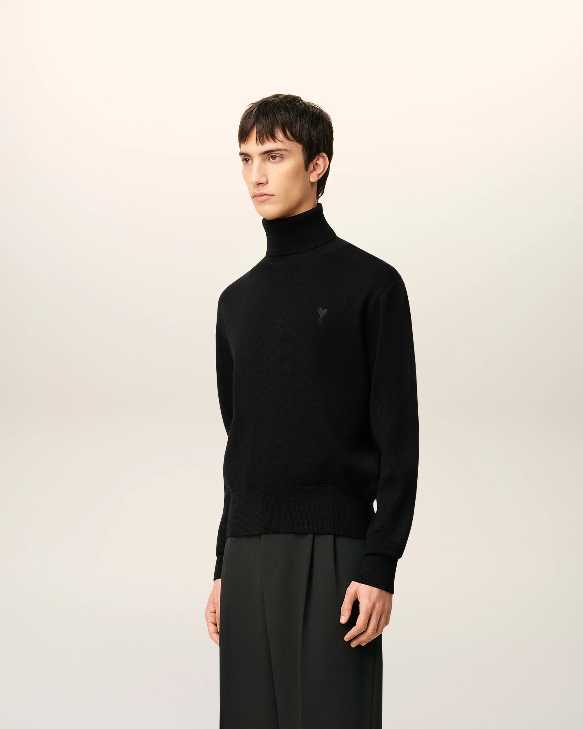 Black turtleneck sweater on a beige background