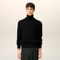 Black turtleneck sweater on a beige background