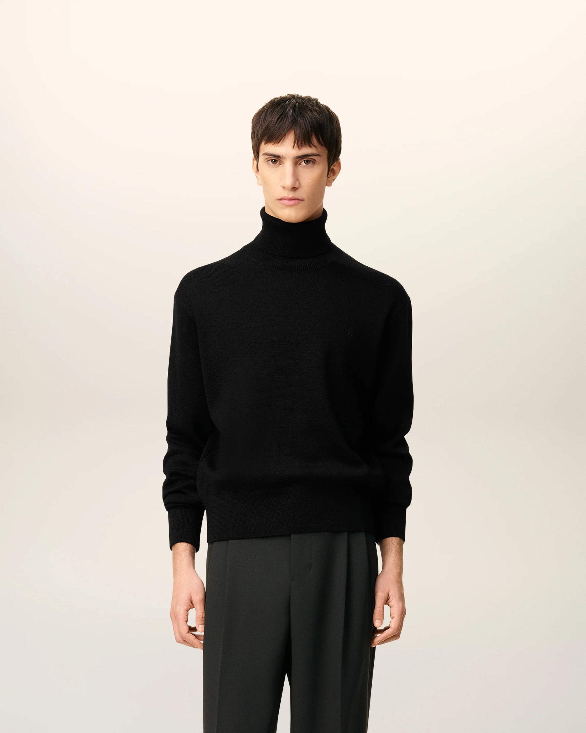 Black turtleneck sweater on a beige background