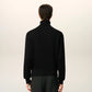 Black turtleneck sweater on a beige background