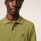 Green polo shirt on a light beige background ami paris