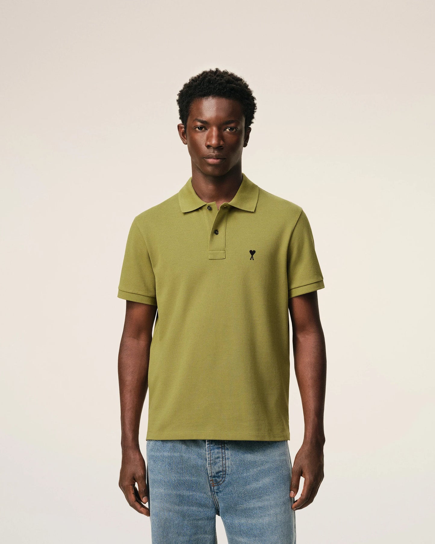 Green polo shirt on a light beige background ami paris