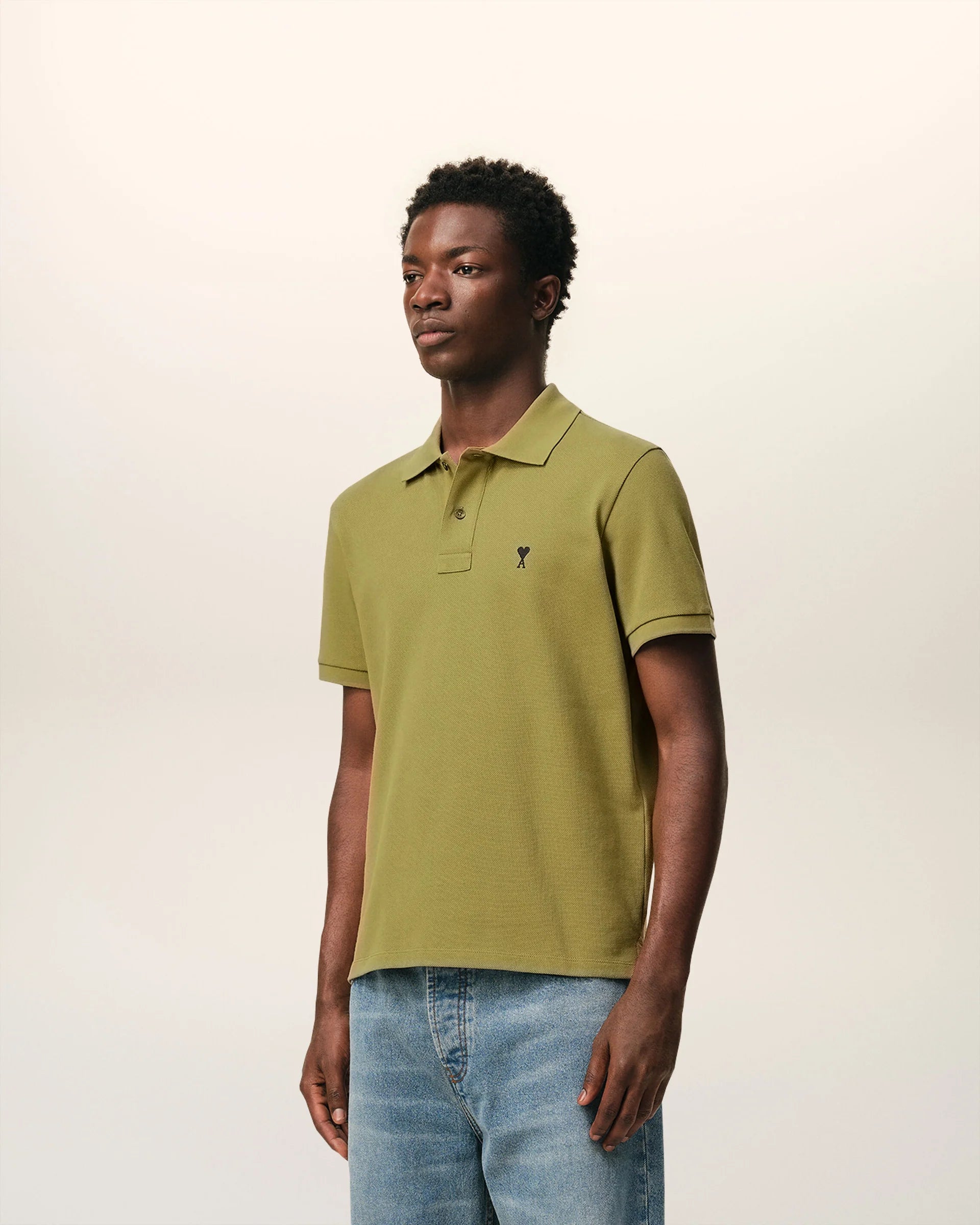 Green polo shirt on a light beige background ami paris