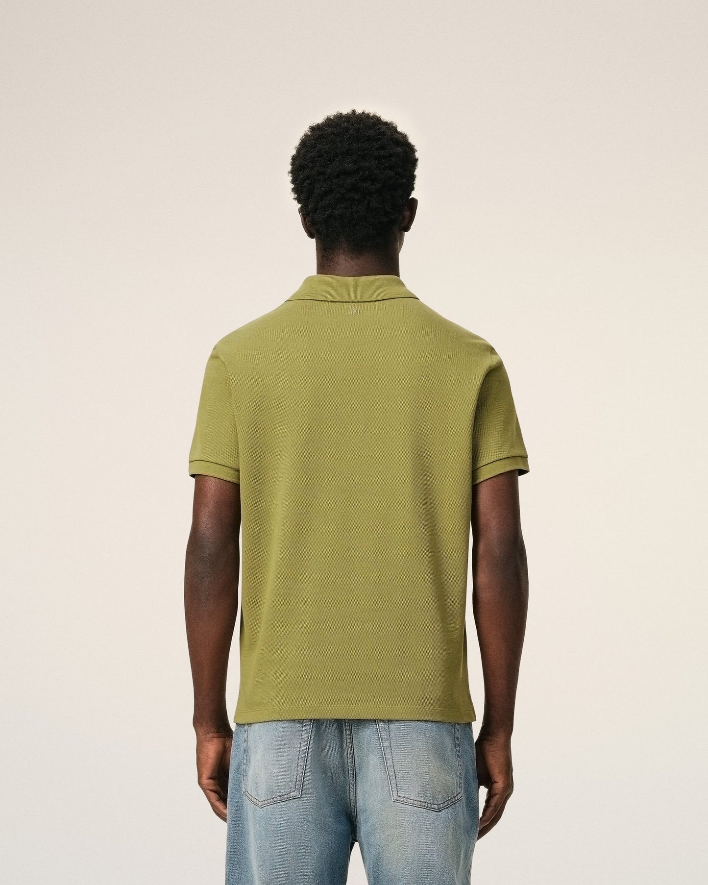 Green polo shirt on a light beige background ami paris