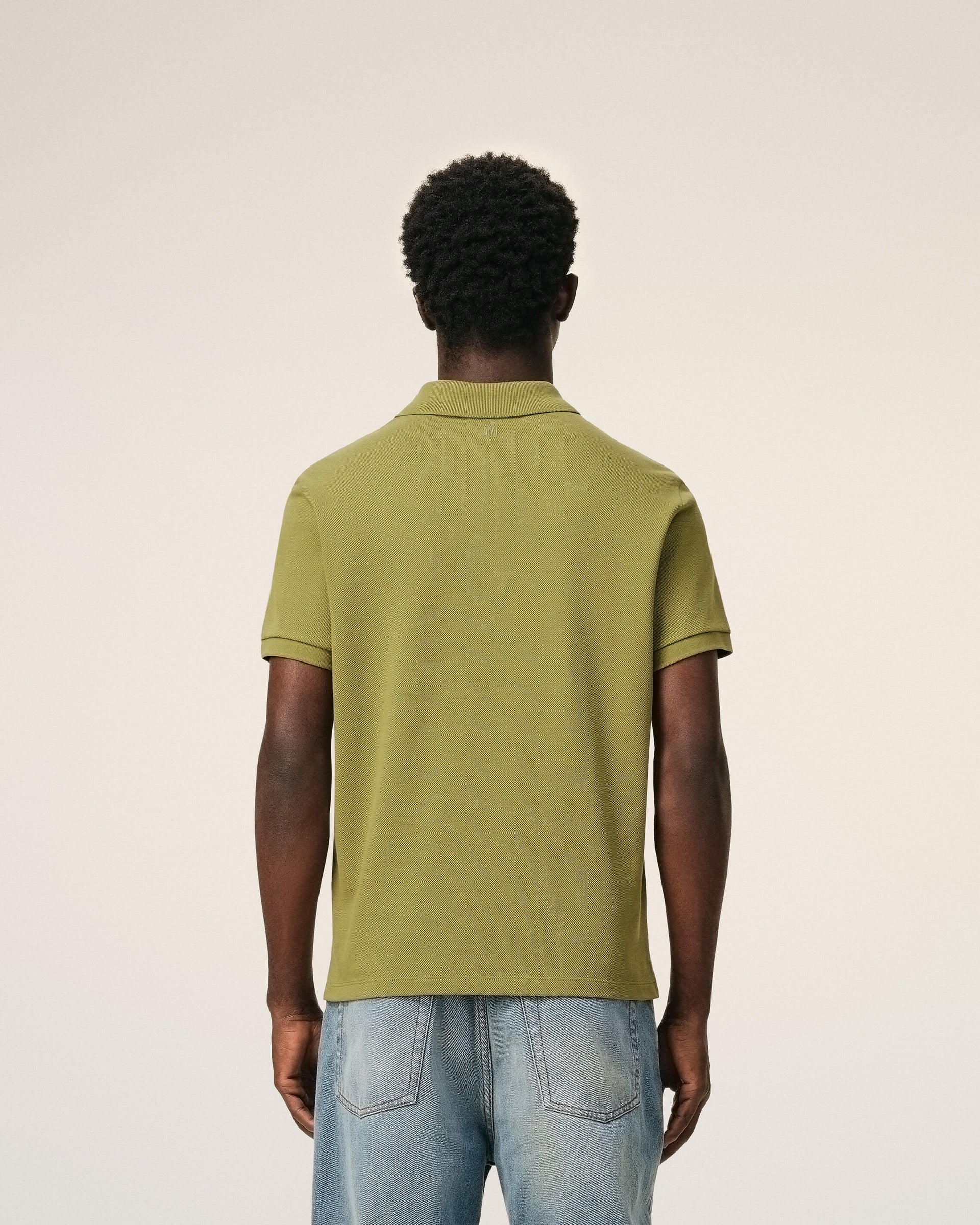 Green polo shirt on a light beige background ami paris