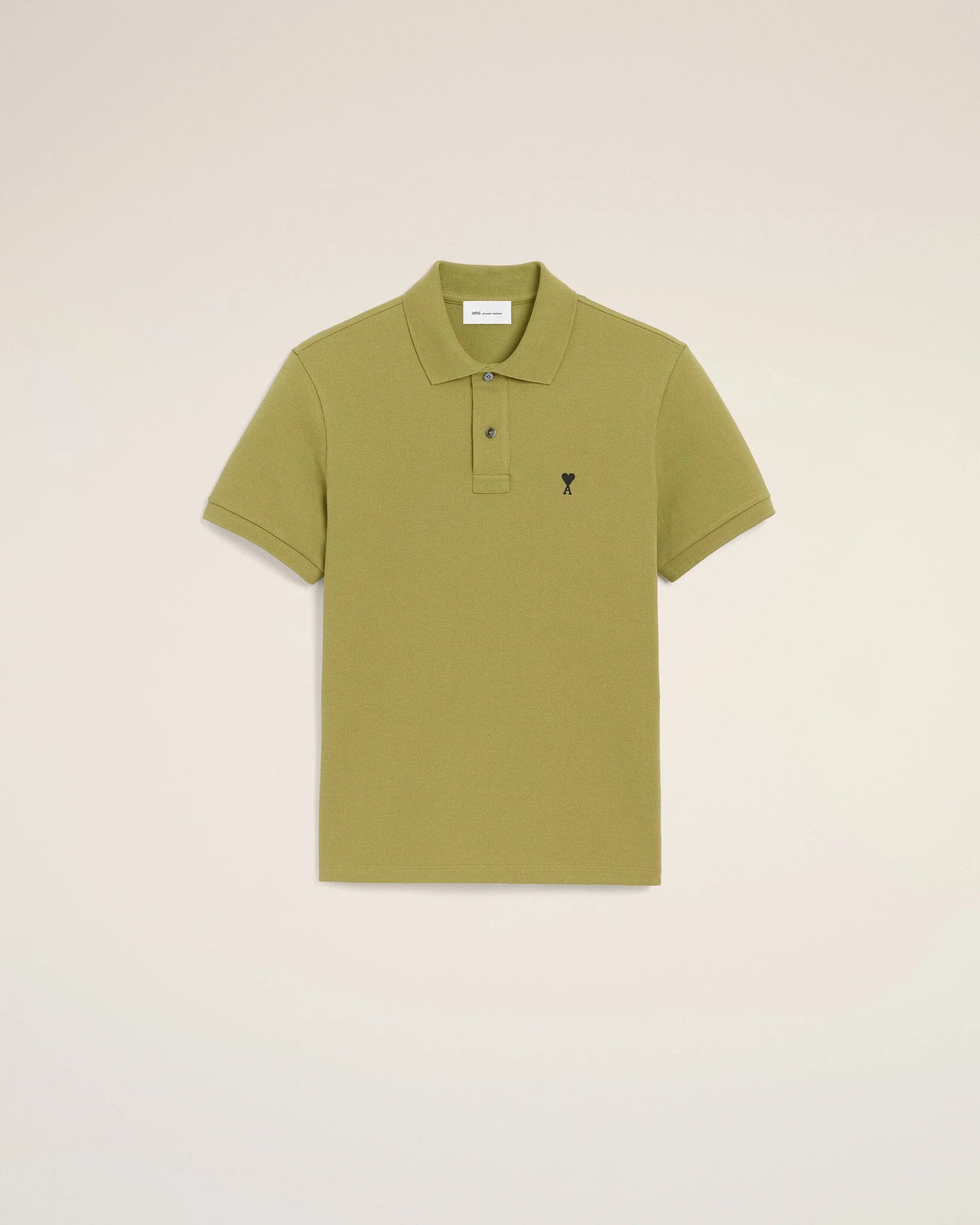 Green polo shirt on a light beige background ami paris