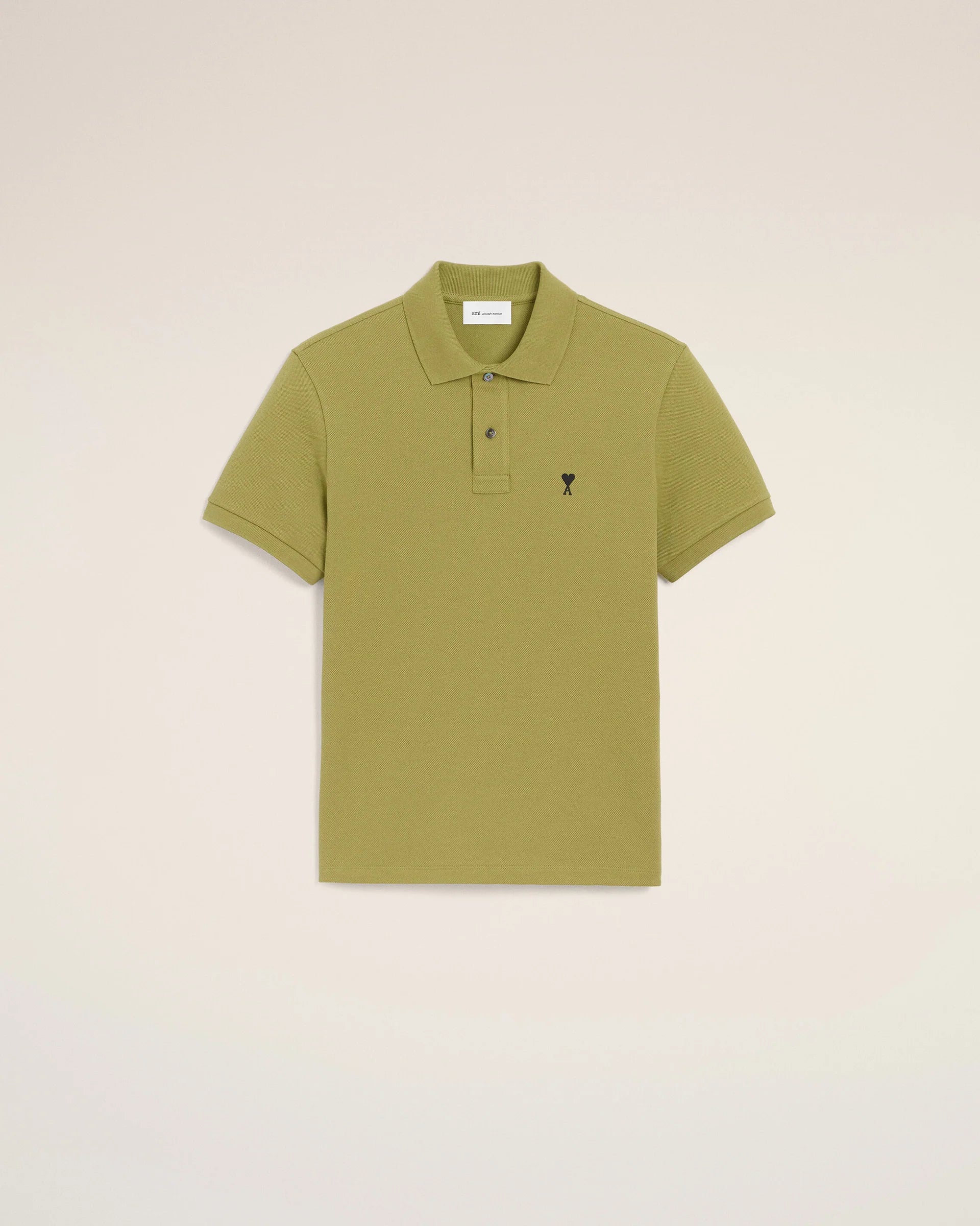 Green polo shirt on a light beige background ami paris