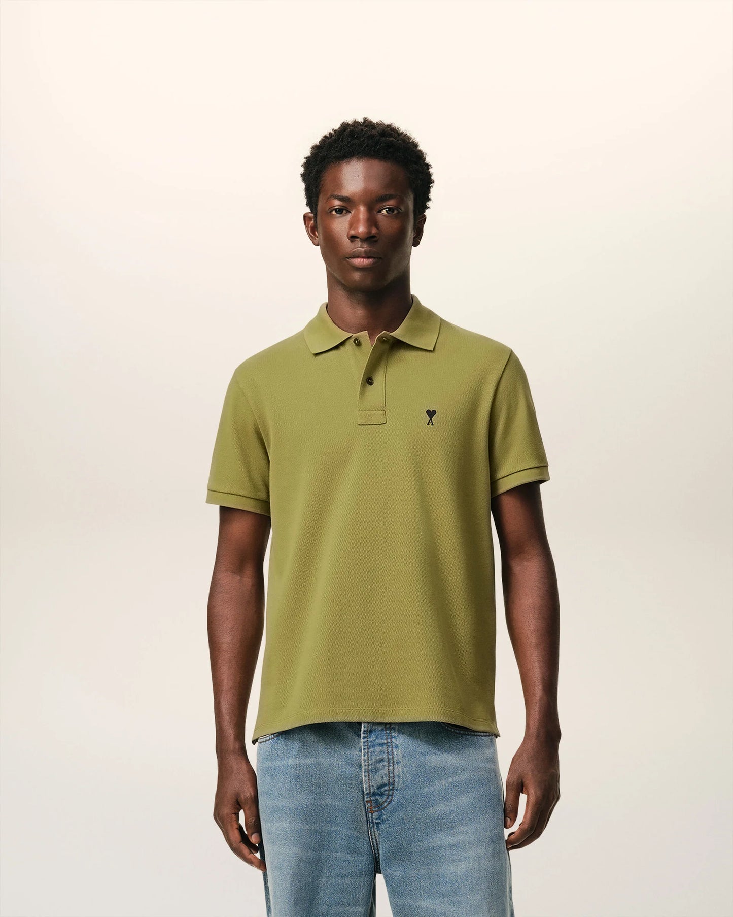 Green polo shirt on a light beige background ami paris