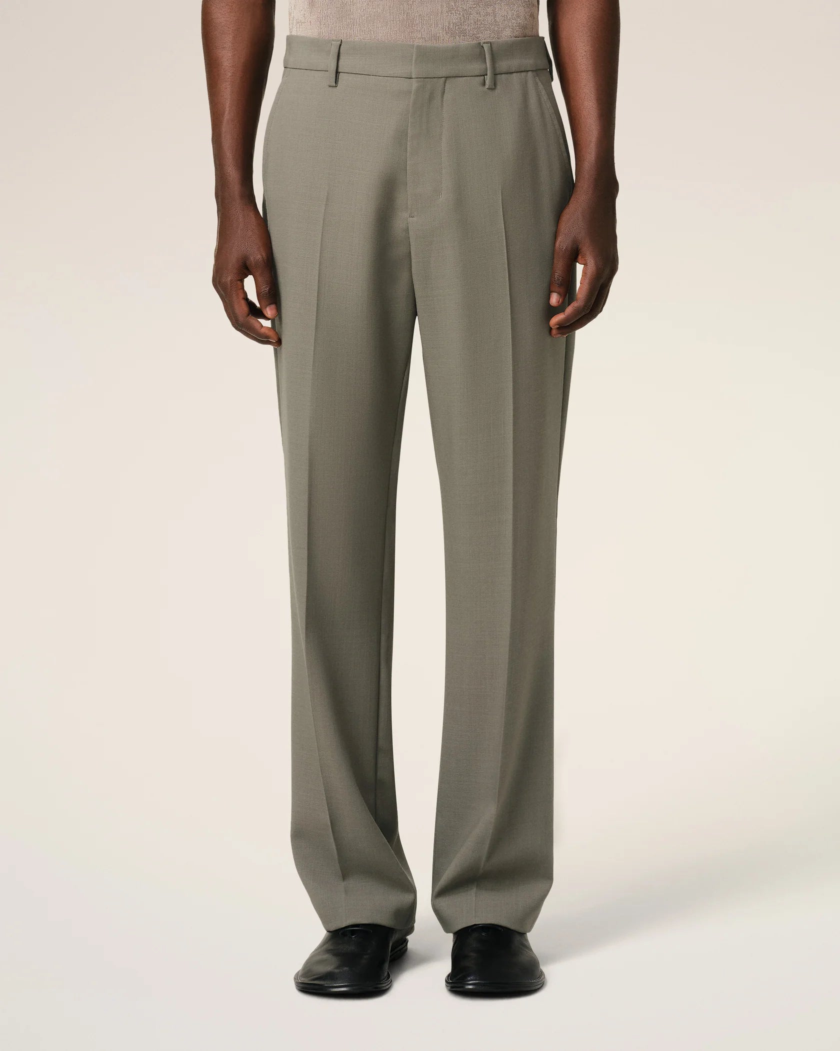 Green pants on a beige background