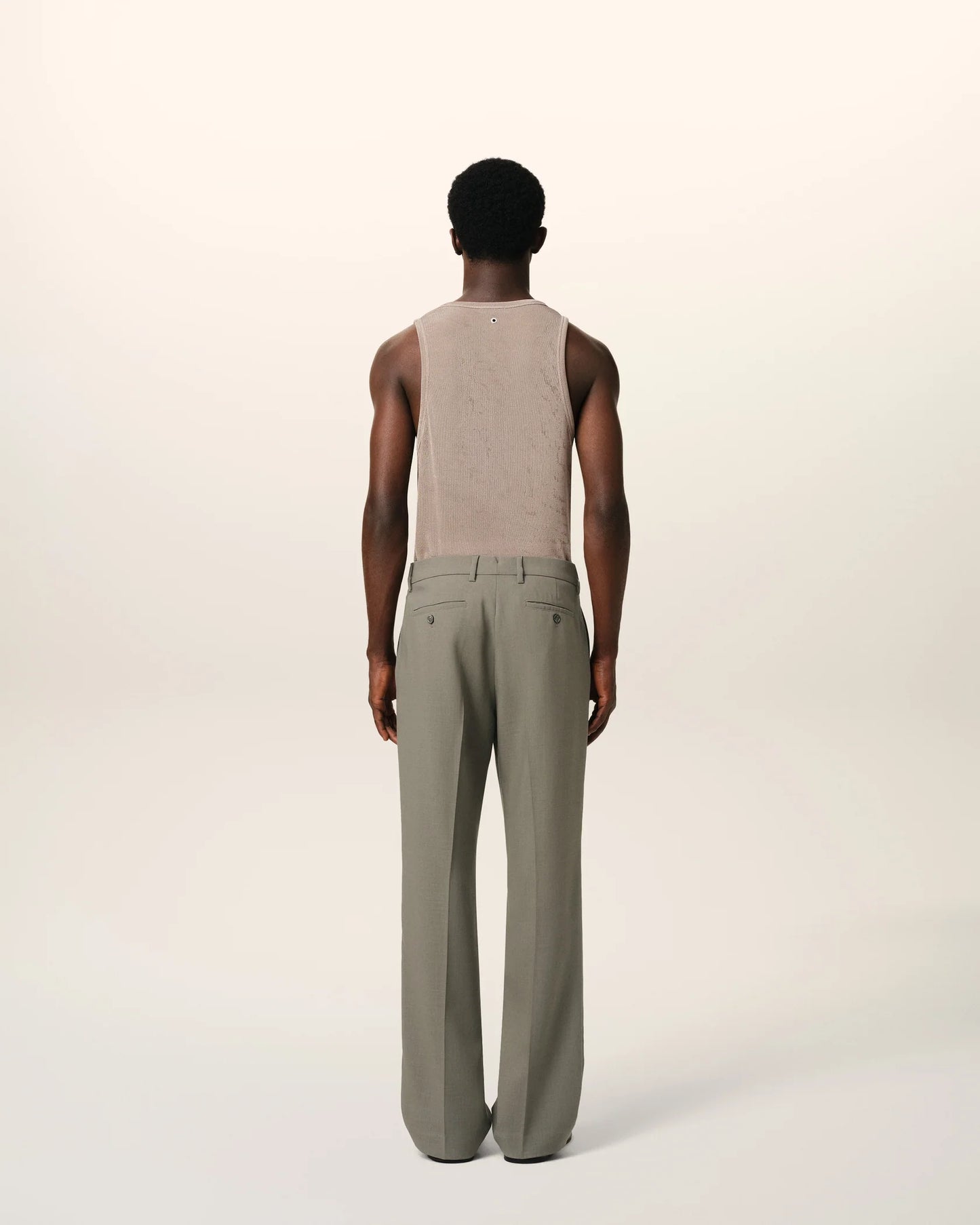 Green pants on a beige background